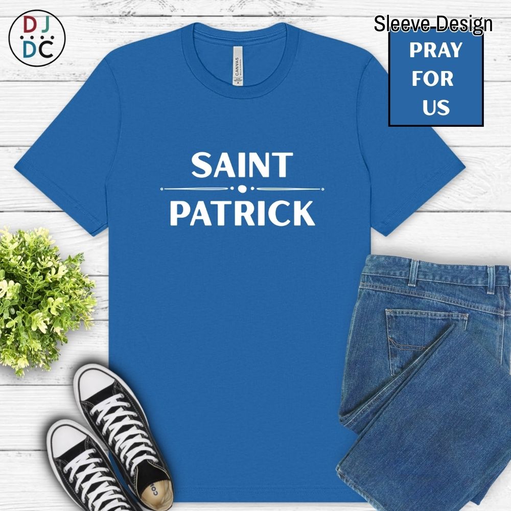 Blue t-shirt with 'Saint Patrick' text, paired with jeans and sneakers on a wooden surface.