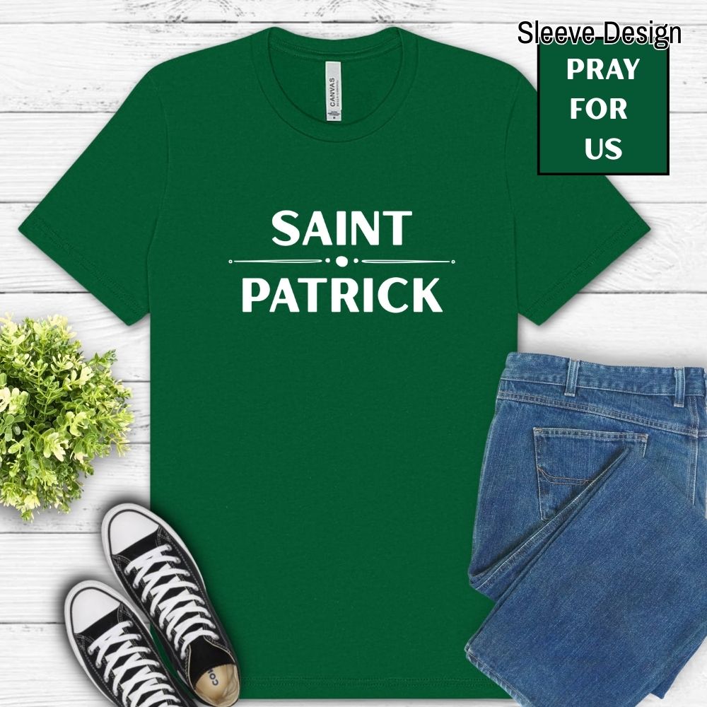 Green t-shirt with 'Saint Patrick' text, paired with jeans and sneakers on a wooden surface.