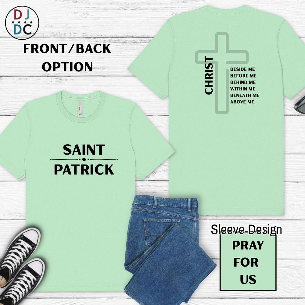 Light green t-shirt with 'Saint Patrick' and 'Christ' designs on a wooden surface with jeans and sneakers.