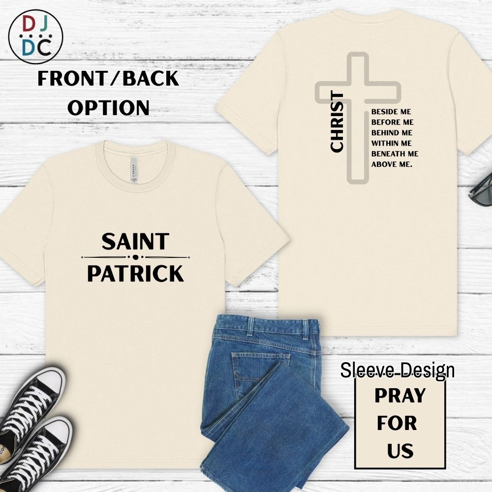 Beige t-shirt with 'Saint Patrick' and cross design on a wooden surface with jeans and sneakers.