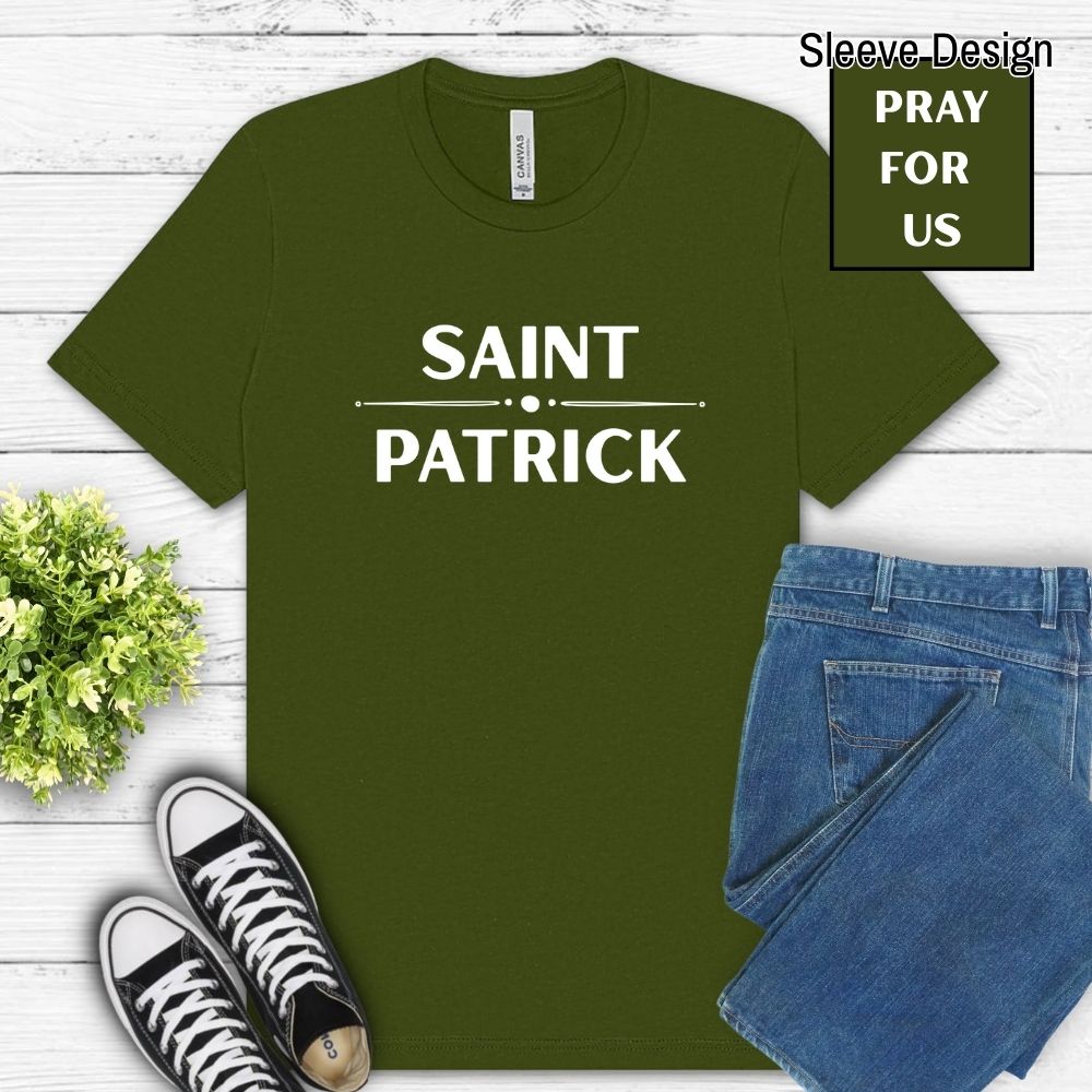 Green t-shirt with 'Saint Patrick' text, paired with jeans and sneakers on a wooden surface.