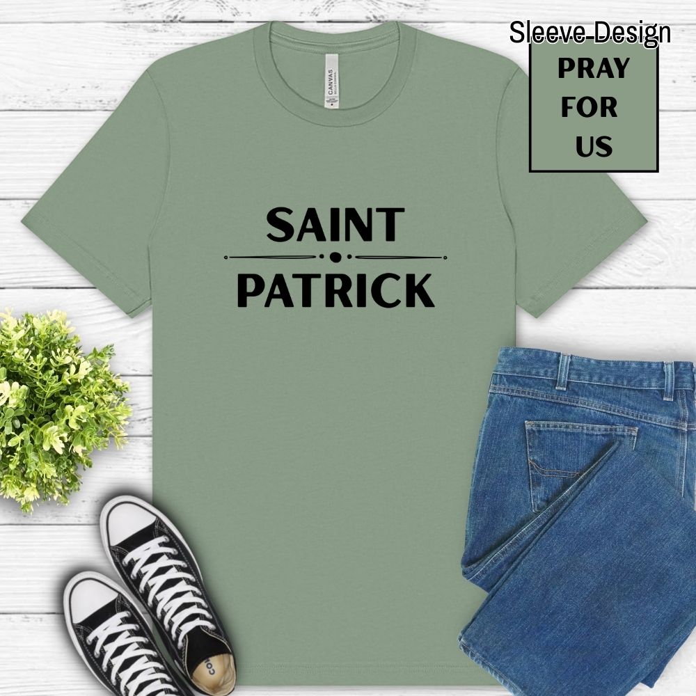Green t-shirt with 'Saint Patrick' text, paired with jeans and sneakers on a wooden surface.