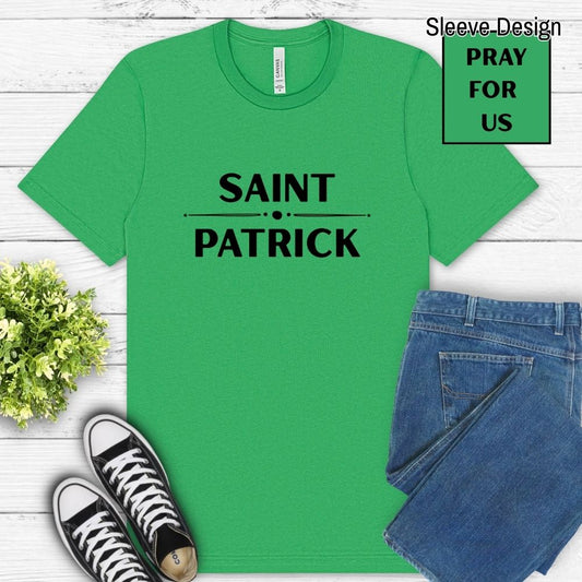 Green t-shirt with 'Saint Patrick' text, paired with jeans and sneakers on a wooden surface.