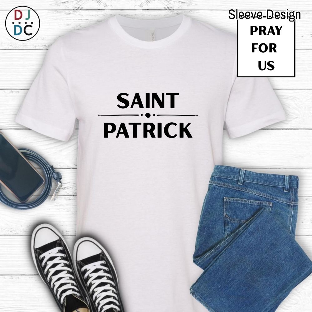 White t-shirt with 'SAINT PATRICK' text, paired with jeans and sneakers on a wooden surface.