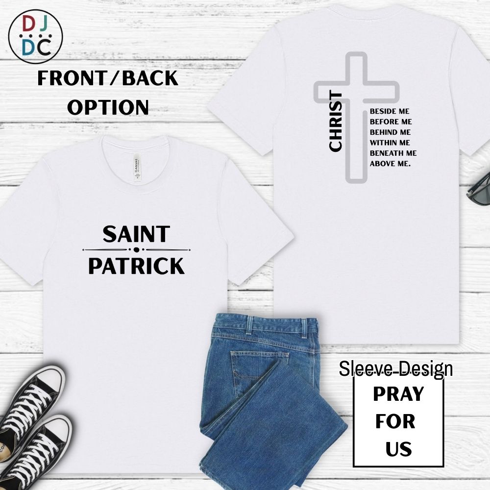 White t-shirt with 'Saint Patrick' and cross design on a wooden surface with jeans and sneakers.